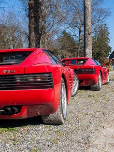 two red sports cars parked next to each other