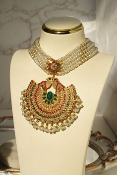 Introducing the Imaari Statement Necklace Set with Maang Tikka and Chandbali Earrings. This exquisite necklace set features multicolor navratan stones with elegant gold plating and high-quality brass filling. The set includes a stunning maang tikka and matching chandbali earrings, making it a perfect style statement for special occasions or parties. The Imaari necklace set is designed to blend tradition with elegance. The intricate design of the maang tikka and the dazzling chandbali earrings co Green Meenakari Choker For Party, Luxury Meenakari Choker Necklace, Gold Meenakari Choker Necklace, Festive Green Meenakari Choker, Festive Gold Meenakari Choker, Ear Chain, Statement Choker Necklace, Statement Choker, Chandbali Earrings