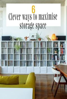 a living room filled with furniture next to a book shelf full of cds and records