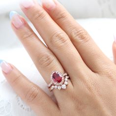 Breathtakingly unique ruby bridal ring set features an oval-shaped large ruby engagement ring set in the vintage floral diamond ring setting. To complete the one-of-a-kind look, a large 7 diamond u-shaped scalloped wedding band is created! This oval ruby and diamond ring bridal set can be made in white, yellow, rose gold, or platinum. ** The hand model's ring size is US ring size 6.25 Jewelry Information Engagement Ring: Center Stone:* Conflict Free Cultured Ruby (lab grown in the USA by Chatham