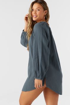 A flowy cover-up dress that has a relaxed long sleeve design and mini length fit. O'Neill Women's woven cover-up 28" In length Front button closure Solid color wash Lightweight, breathable fabrication 100% Cotton Crinkle Double Gauze Relaxed Fit Long Sleeve Top For Beach Cover-up, Chic Long Sleeve Cover-up For Daywear, Chic Long Sleeve Loungewear Cover-up, Spring Beach Tunic With Long Sleeves, Long Sleeve Beach Tunic For Spring, Spring Breezy Cover-up With Long Sleeves, Breezy Long Sleeve Spring Cover-up, Flowy Long Sleeve Cover-up, Breezy Long Sleeve Flowy Top