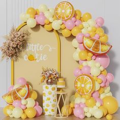 a table topped with balloons and oranges