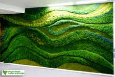 a green wall in an office with grass growing on it's walls and the words,