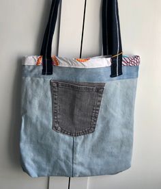 a denim bag hanging on the wall