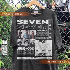 a t - shirt hanging on a fence with the words seven seven in front of it