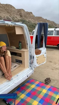 a woman sitting in the back of a white truck