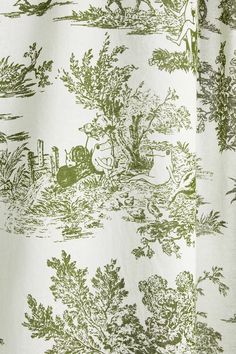 a green and white toiler print curtain with an animal in the woods on it