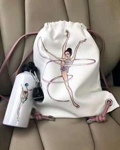 a drawstring bag sitting on top of a car seat next to a water bottle