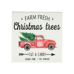 a red truck with a christmas tree on the back is parked in front of a sign that reads farm fresh christmas trees cut & carry cedar pine - fir