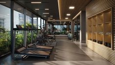 there are many treadmills lined up in the room with glass walls on both sides