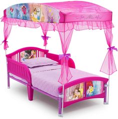 a pink princess bed with canopy and mosquito netting over it's head, in front of a white background