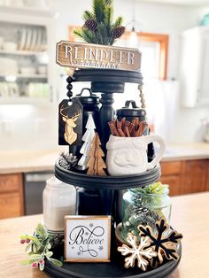 a three tiered tray with christmas decorations on it