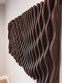 a wall sculpture made out of wooden strips