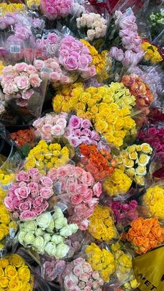 many different colored flowers are on display for sale