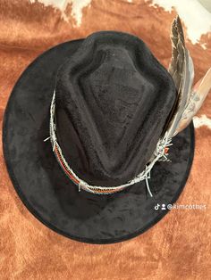 ⭐️⭐️⭐️INTRODUCING: ⭐️⭐️⭐️ CADILLAC COWBOY PLATINUM COLLECTION- RUIDOSO Put a little style in your stride and a hat on your head. Our hats are not just an accessory, they're an attitude. Embrace the fun, the flair, and the endless possibilities. #HatYourHeartOut #CustomHats #Texasstyle #cadillachats https://Cadillachats.com BRAND NEW STYLE!! Arrowhead SHAPED CROWN- BE THE FIRST TO HAVE ONE OF THESE SUPER CUTE STYLE HATS! Black hat, with a leather   band, leather barbed wire band and a custom painted feather along  with various feathers, shotgun shell pin and a rhinestone chain wrap.  ⭐️⭐️ONLY ONE AVAILABLE!⭐️⭐️ This is a Gorgeous hat! One size fits most! Hand wash only, lint brush for dusting Custom Black Hat With Short Brim, Rodeo Mini Hats With Short Brim, Handmade Black Fedora For Rodeo, Rodeo Mini Hat With Short Brim, Custom Black Fedora For Kentucky Derby, Western Style Costume Hats With Short Brim, Adjustable Black Mini Hats For Western-themed Events, Custom Black Costume Hat, Western Style Festival Mini Hats