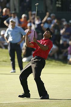 a man in red shirt and black pants playing golf