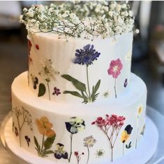 a three tiered cake decorated with flowers