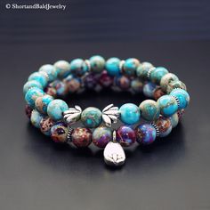 "❖ This listing is for two bracelets ❖ Bracelet #1 - Mint Blue Sea Sediment Imperial Jasper (Color enhanced) Lotus Bracelet Bracelet #2 - Purple & Blue Sea Sediment Imperial Jasper (Color enhanced) Lotus Bracelet ❖ JASPER: Natural approx. 8mm gemstone ❖ ♥ Stability ♥ Tranquility ♥ Comfort ♥ Peace ♥ Stress relief ♥ Patience ♥ Letting-go ❖ SPACERS & LOTUS CHARM (Approx. 7X12MM): Antique pewter charms made in USA. ❖ Durable Elastic Stretch Cord. ❖ All our gemstones are natural so you may see some v Holistic Turquoise Beaded Bracelets With Natural Stones, Turquoise Spiritual Bracelets For Friendship, Blue Natural Stone Bracelets For Friendship, Blue Natural Stones Bracelets For Friendship, Blue Natural Stones Friendship Bracelets, Turquoise Healing Bracelet With 108 Beads, Spiritual Turquoise Bracelets With 108 Beads, Turquoise Hand Wrapped Bracelets For Meditation, Blue Gemstone Beads Bracelets For Friendship