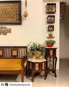 a living room filled with furniture next to a wall mounted art on it's walls