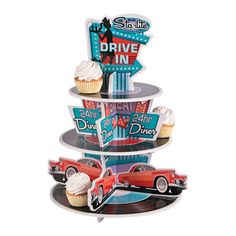 three tier cupcake stand with cars and signs on the top, in front of a white background