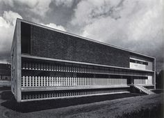 an old black and white photo of a building that has been designed to look like a brick structure