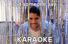 a man standing in front of a mirror with the caption did someone say karaoke?