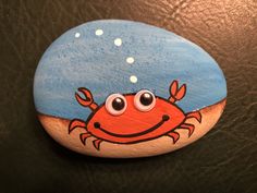 a painted rock with a crab on it