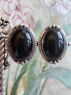 This is a vintage, signed, EB (Edward Becenti) hand made, Navajo Native American sterling silver and black onyx, pair of clip on earrings. These are marked sterling and have tested positive for sterling These earrings measure a hair over 1.25 inches length. Don't forget to stop in at my other Etsy shop... http://www.etsy.com/shop/xtdesigns. Follow me on Twitter at... MyYiayiaHadThat@MyYiayiaHadThat. If you have a wish list or are looking for something specific, please ask. I may have exactly wha Elegant Black Concho Jewelry, Black Southwestern Jewelry With Turquoise Accents, Black Southwestern Concho Jewelry, Southwestern Black Concho Jewelry, Collectible Black Bohemian Jewelry, Black Bohemian Collectible Jewelry, Bohemian Black Collectible Jewelry, Vintage Black Oval Earrings, Black Oval Vintage Earrings