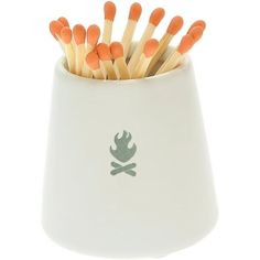 a white cup filled with lots of matches