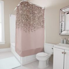 a bathroom with a pink shower curtain and white toilet