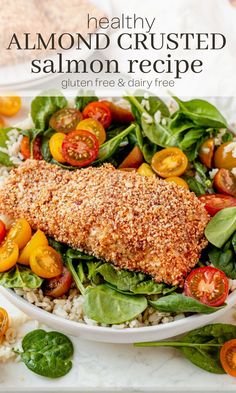 a white plate topped with salmon and spinach covered in breaded crumbs