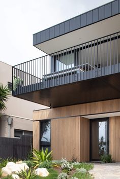 a modern house with wooden siding and balconies