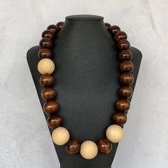 Modern Wood Bead Necklace, Unisex Wooden Necklace, Chunky Wood Necklace UNISEX Wood Necklace, Two Tone Wood Necklace, Mens Wood Necklace This unique necklace was hand beaded using a mix of large 25mm round dark brown wooden beads and four extra large 30mm round natural pine beads in a fresh, modern design. The necklace measures approximately 27 inches long and is securely fastened with a silver lobster clasp. Perfect for any gender. Length can be adjusted if needed - just ask! Check out more fab Everyday Brown Jewelry With Large Beads, Brown Wooden Beads Round Jewelry, Brown Wooden Beads Jewelry, Brown Round Wooden Beads Jewelry, Everyday Brown Wooden Beaded Necklaces, Brown Polished Beads Necklace, Wooden Round Bead Necklaces For Gifts, Wooden Round Bead Necklaces As Gift, Wooden Round Beads Necklace As Gift