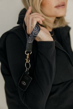 Smile Squad Wrist Lanyard Hang tight to your possessions with the Smile Squad wrist lanyard. It is perfect to keep track of your keys and other accessories. Complete the look with the coordinating Smile Squad case and Apple watch band and you're good to go! Design: Beige smiley faces on a black backgroundStrap Dimensions: 3.7 inches long, .75 inches wide Lanyard Photoshoot, Wrist Lanyard, Smiley Faces, The Smile, Plus Size Shopping, Blankets For Sale, Post Ideas, Apple Watch Band, Smiley Face