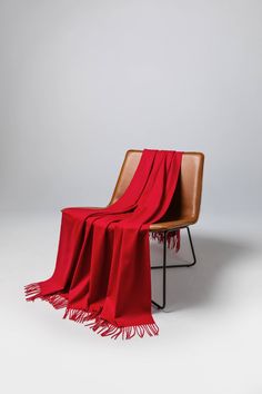 a chair with a red blanket on it