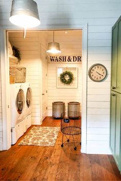 a washer and dryer sitting in a room next to each other on top of a hard wood floor