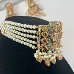 * Hyderabadi Nauratan Pearl Necklace Set. *Antique gold and Champagne Stones *Premium quality with premium gemstones. *Multi colored, perfect for any occasion. *Handmade and carved by talented artisans *Support small business Luxury Traditional Kundan Pearl Necklace, Luxury Gold Dual-tone Kundan Necklace, Gold Kundan Multi-stone Temple Necklace, Gold Bohemian Brass Kundan Necklace, Gold Multi-stone Kundan Bollywood Necklace, Pearl Mala, Pakistani Bridal Jewelry, Necklace Set Indian, Pearl Necklace Set