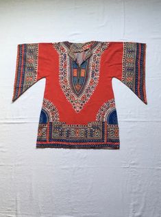 "1970s handmade pullover dashiki shirt soft cotton multi-color tapestry/batik style print main color-red wing sleeve 2 front hand pockets good vintage condition, light wear a few fabric worn spots (see photos) no size tag, see below measures, lying flat, neck to sleeve-15\" chest-19\" hem-22 1/2\" length-31 1/2\" length hits at upper thigh, more or less, depending on wearers height" Handmade Pullover, Kaftan Shirt, Style Batik, Dashiki Shirt, Printed Palazzo Pants, Handmade Shirts, Front Hand, Red Wing, Long Sweaters Cardigan