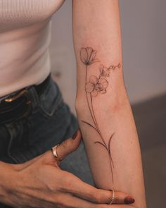 a woman with a flower tattoo on her arm