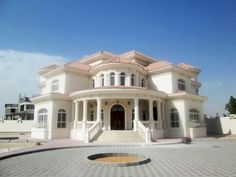 a large white house sitting on the side of a road