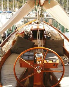 the inside of a sailboat with lots of pillows