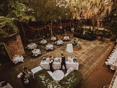 an aerial view of a wedding reception in the courtyard