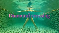 a woman in a blue swimsuit under water with the words diamond crossing above her