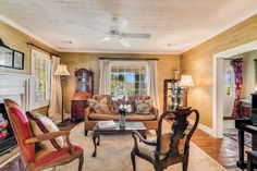 a living room filled with furniture and a piano