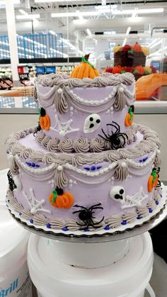 a three tiered cake decorated with halloween decorations