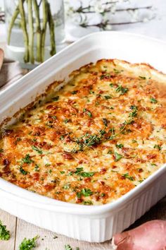 a casserole dish with cheese and herbs