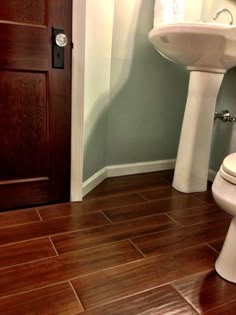 the bathroom is clean and ready to be used by someone who likes wood flooring