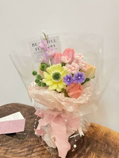 a bouquet of flowers sitting on top of a wooden table