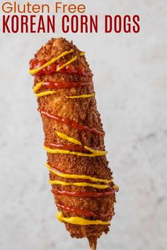 a fried chicken skewer with ketchup and mustard drizzled on top