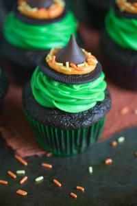 a cupcake with green frosting and a chocolate cone on top